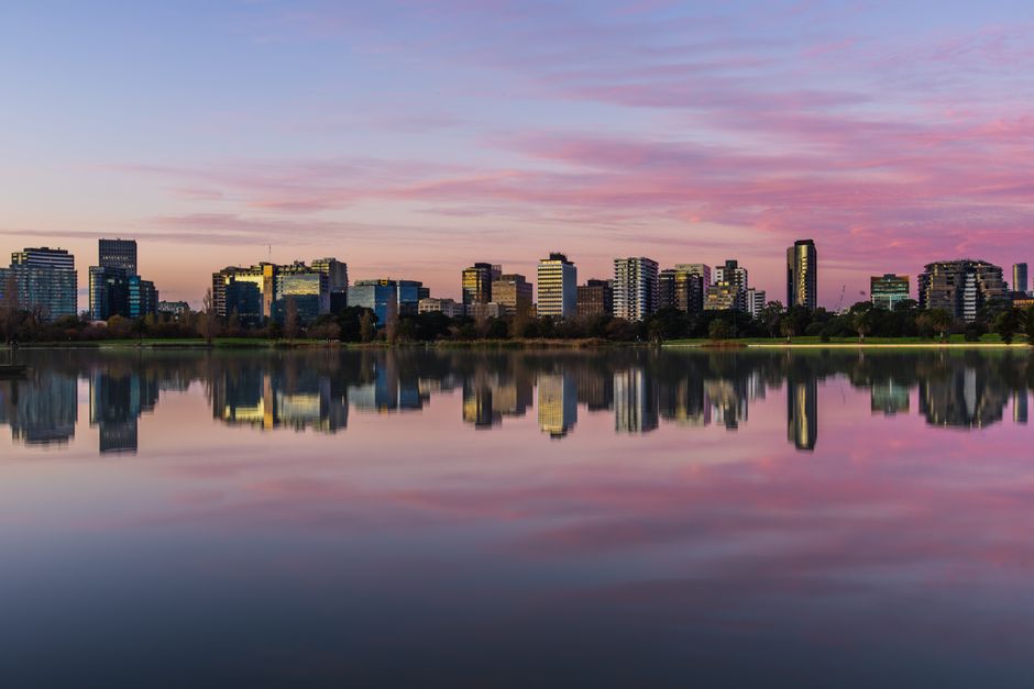 Captured at twilight, this skyline reflects beautifully in a tranquil lake.