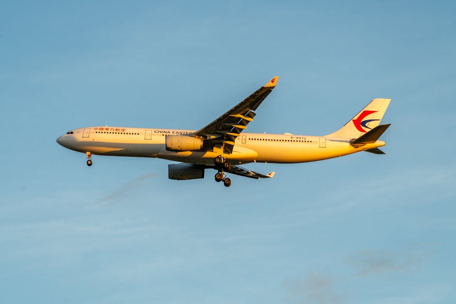 A China Eastern Airlines Airbus A330 flying against a clear blue sky during the day.