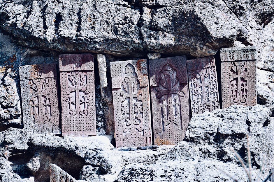 Historic Armenian khachkars carved into eroded rocks, showcasing religious art.