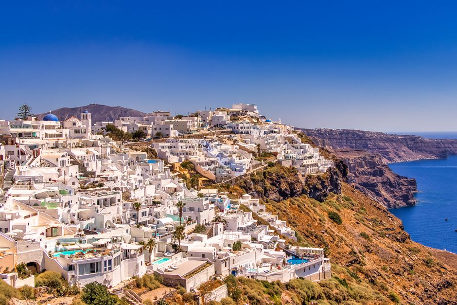 A breathtaking view of Santorini's iconic whitewashed buildings against a vibrant blue sea.