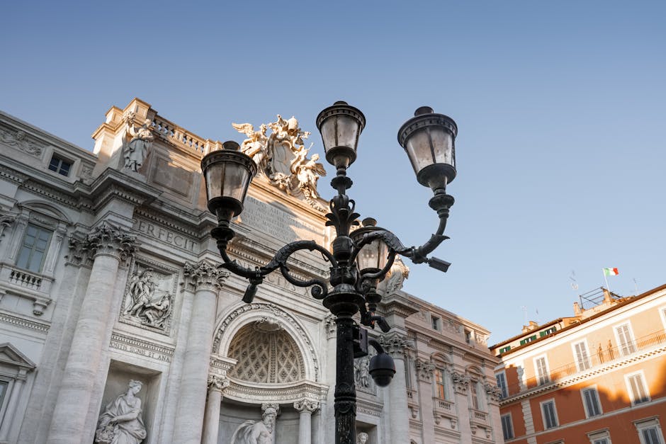 Street lamp against iconic Italian historical architecture, under clear sky.