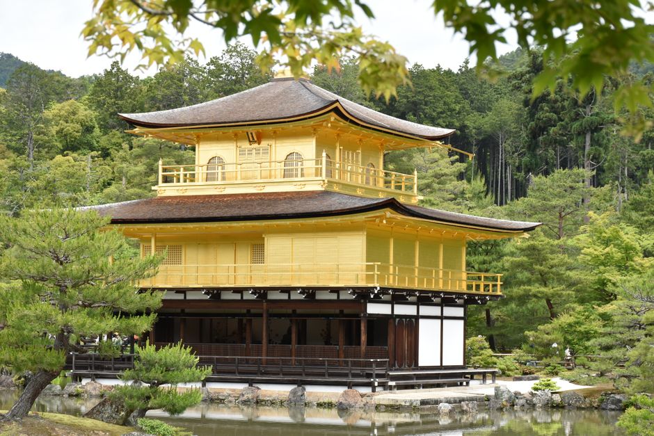 Captivating view of Kinkaku-ji, the iconic Golden Pavilion in Kyoto, Japan surrounded by lush greenery.