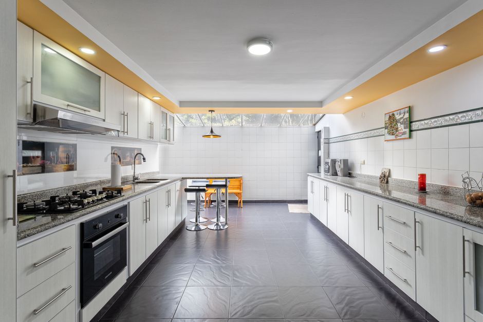 A sleek and spacious kitchen interior in Bogotá, Colombia, featuring modern design and ample lighting.