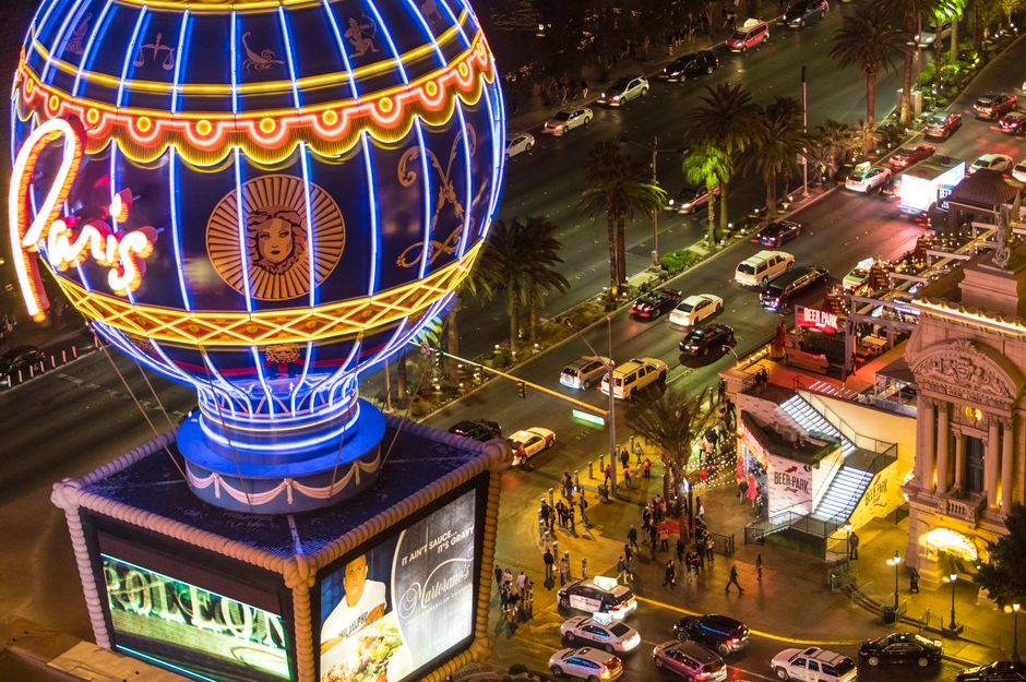 Illuminated view of the iconic Paris Hotel balloon on the Las Vegas Strip at night.