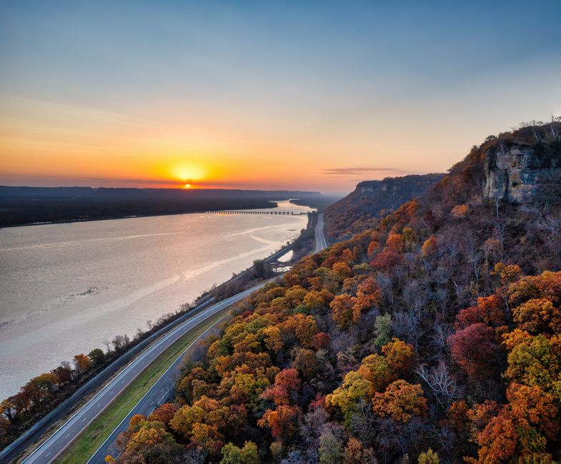 A stunning aerial view of autumn foliage and sunset over the Mississippi River in Minneiska, MN.