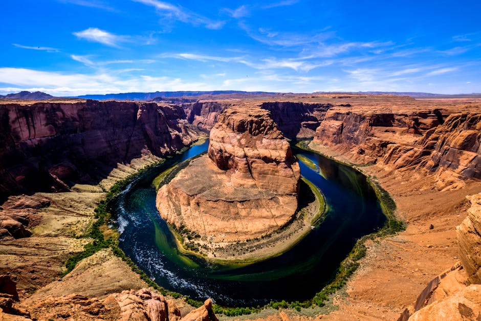 Stunning daytime aerial view of the iconic Horseshoe Bend along the Colorado River in Arizona.
