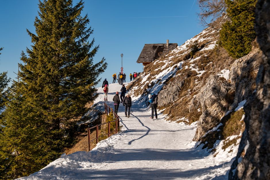 Vibrant winter hiking scene in Furlanija-Julijska krajina, Italy with hikers on a snowy tr